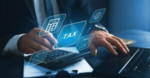 Close-up of financial paperwork, calculator, and laptop symbolizing analysis of new tax deduction rules from the One Big Beautiful Bill Act
